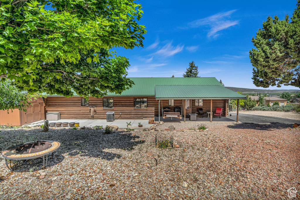 Back of property featuring a patio area and an outdoor fire pit