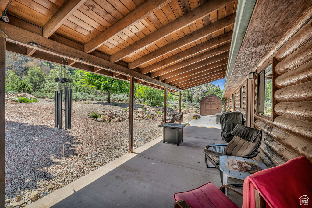 View of patio / terrace featuring a storage unit