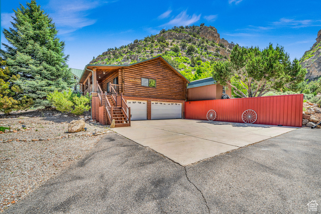 View of side of property with a garage and a mountain view