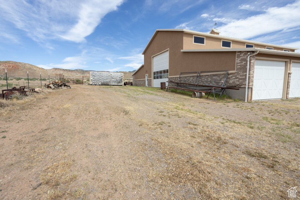 View of yard with a garage and a mountain view