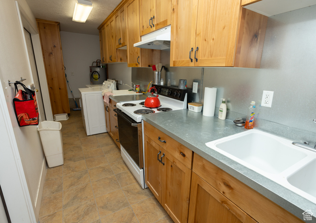 Kitchen featuring light tile flooring, washing machine and clothes dryer, sink, white electric stove, and electric water heater