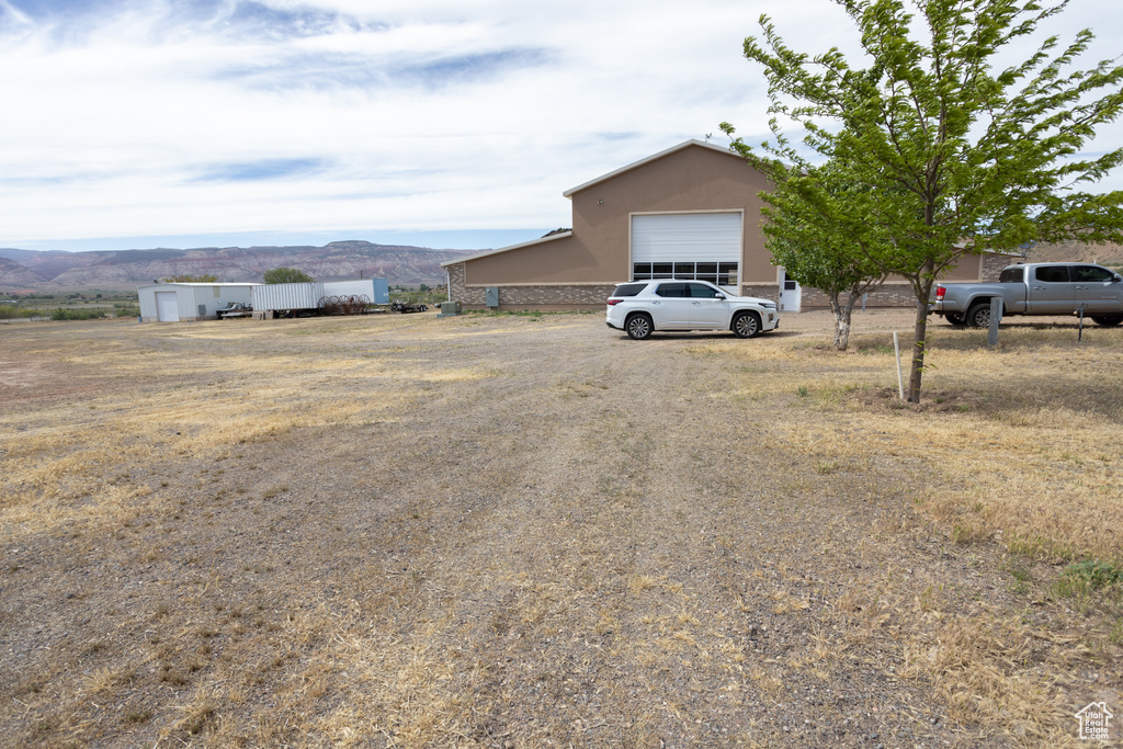 View of yard with a garage and a mountain view