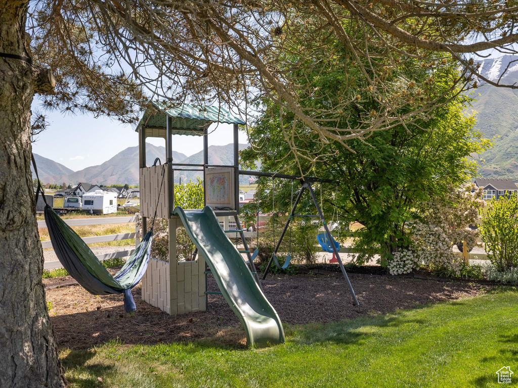 View of jungle gym with a mountain view