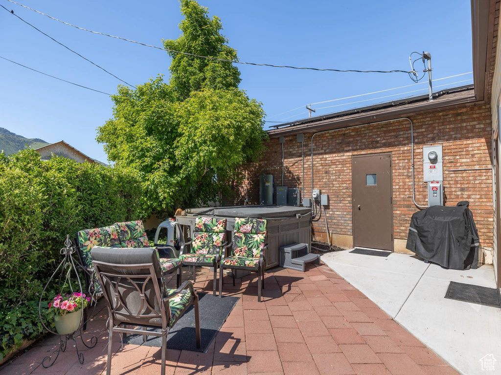 View of terrace featuring a hot tub