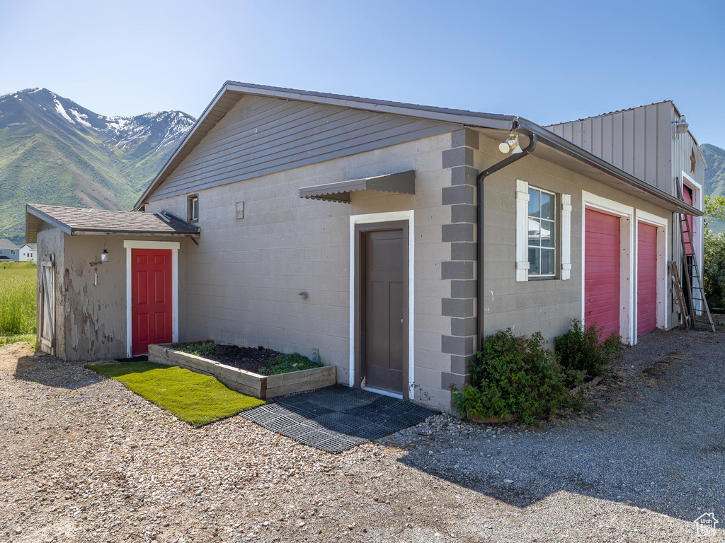 Ranch-style home featuring a garage and a mountain view