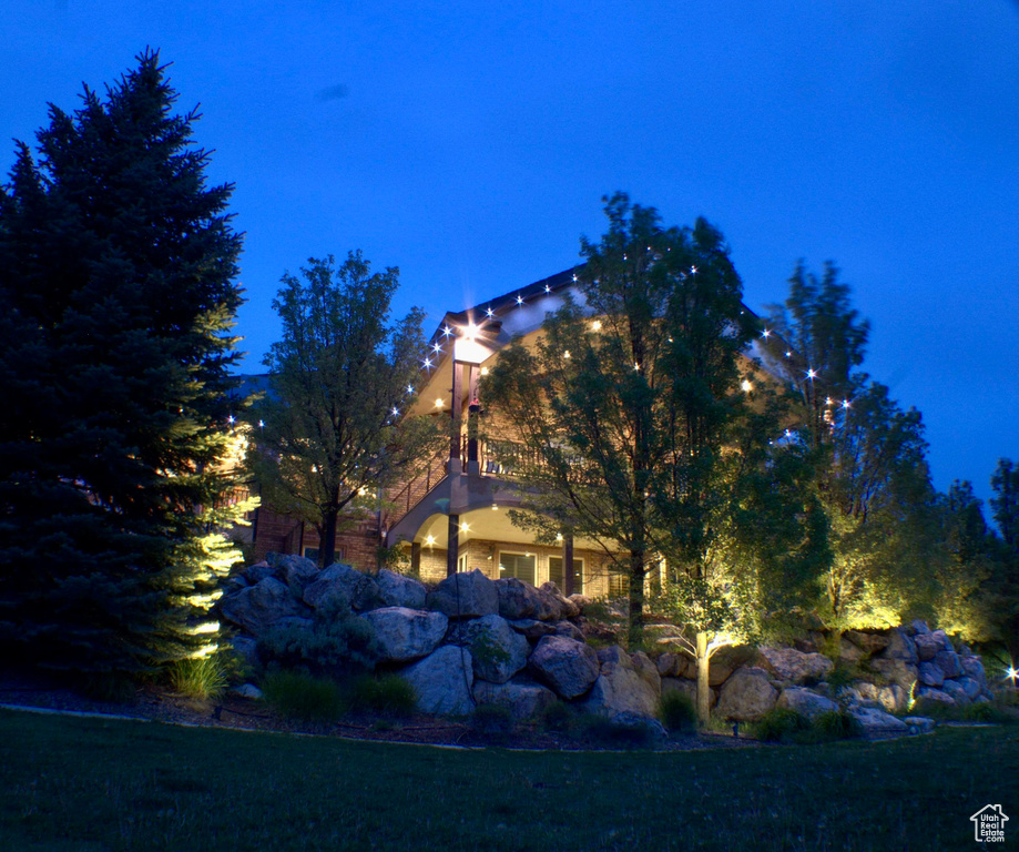 Property exterior at night with a lawn