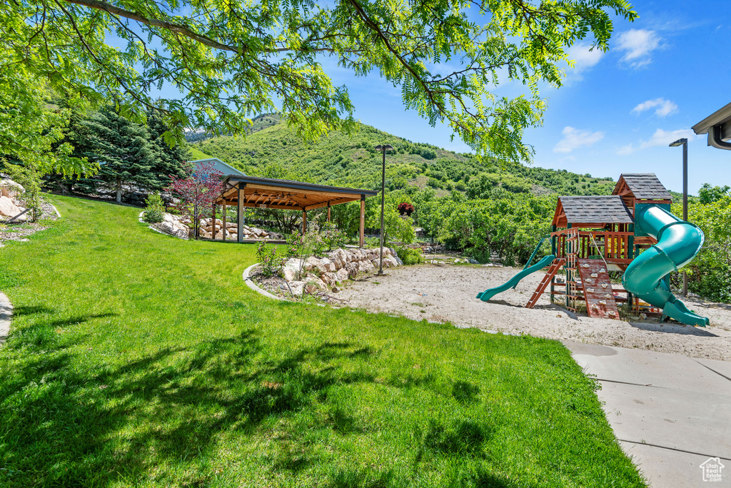 View of yard with a playground and a gazebo