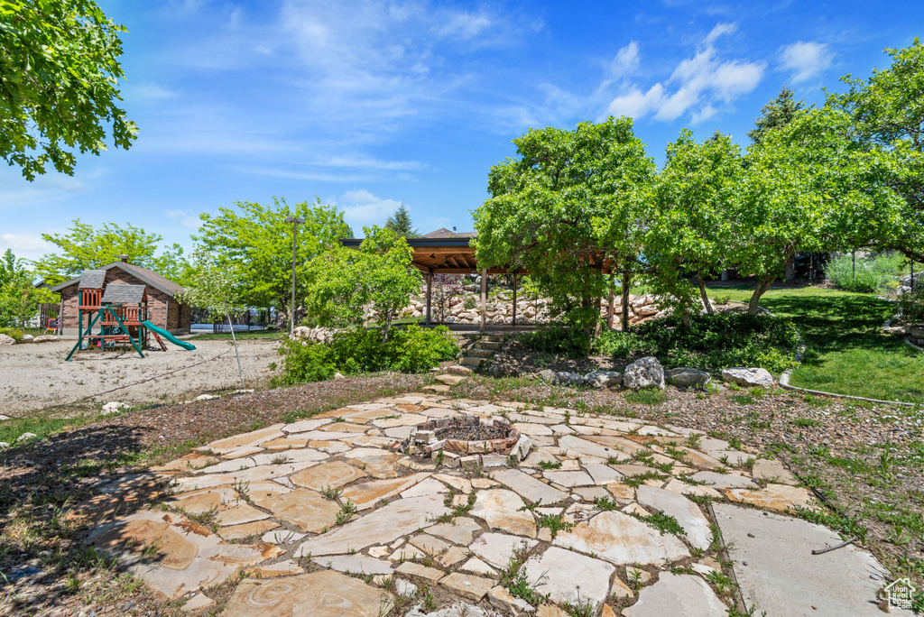 View of yard with a patio area and a playground