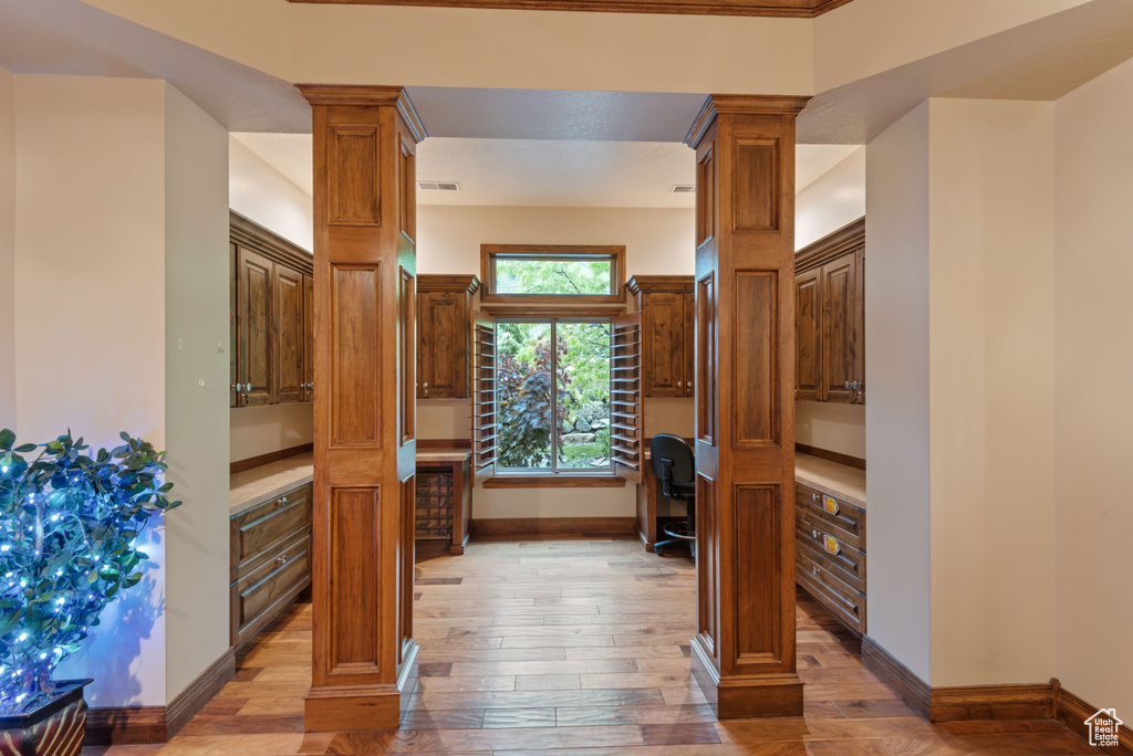 Interior space featuring light wood-type flooring and ornate columns