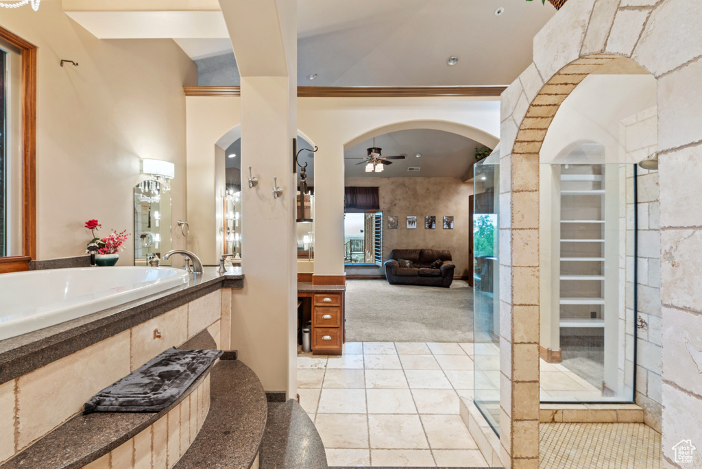 Bathroom featuring ornamental molding, shower with separate bathtub, ceiling fan, tile floors, and vanity