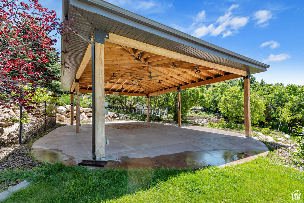 View of terrace with ceiling fan and a gazebo