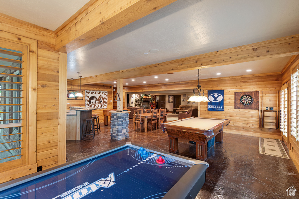 Game room featuring beamed ceiling, indoor bar, and pool table