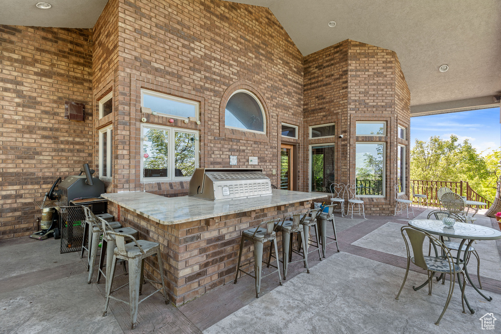 View of patio / terrace with an outdoor bar and exterior kitchen