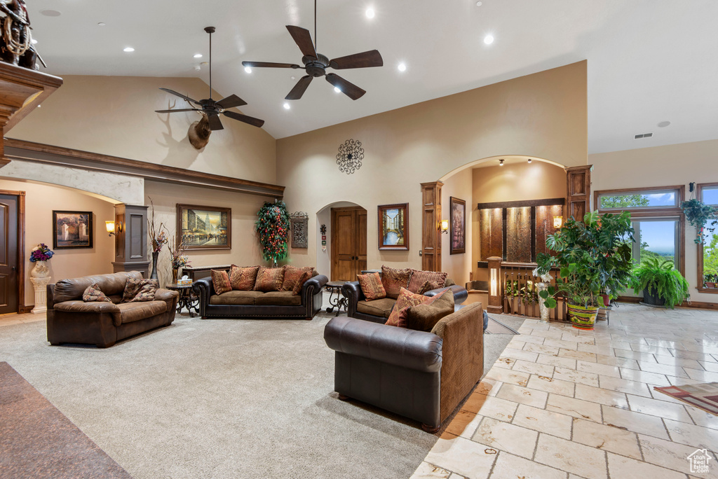 Tiled living room with high vaulted ceiling and ceiling fan