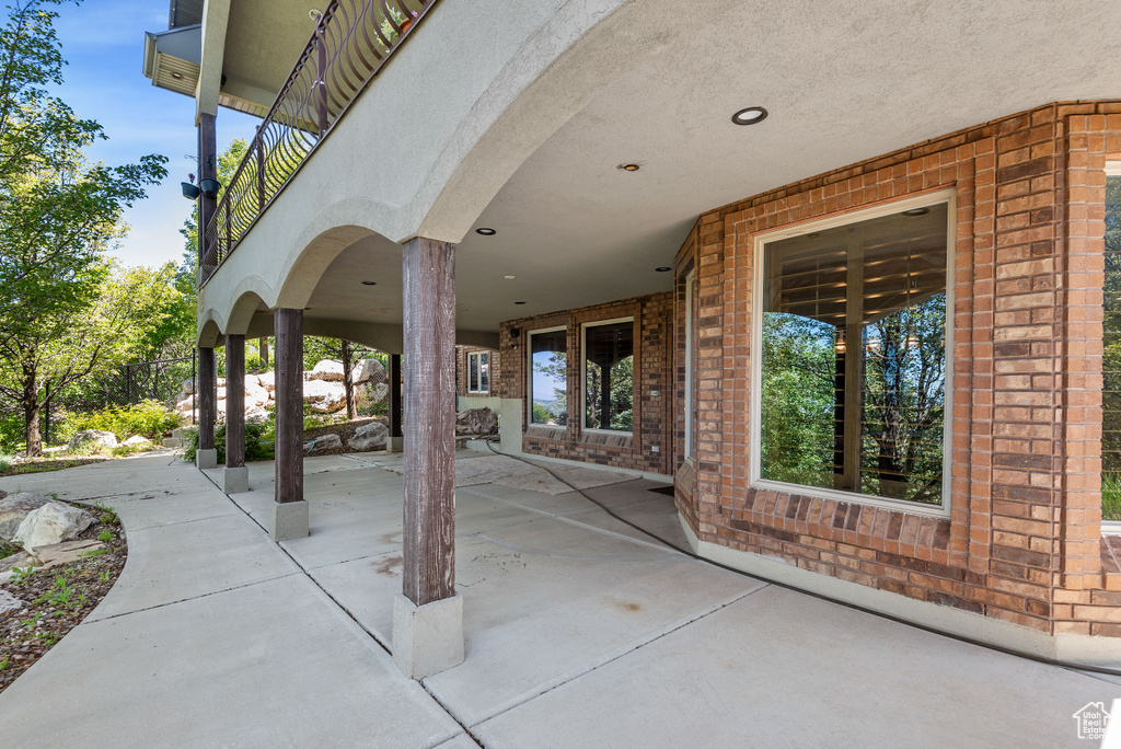 View of patio with a balcony