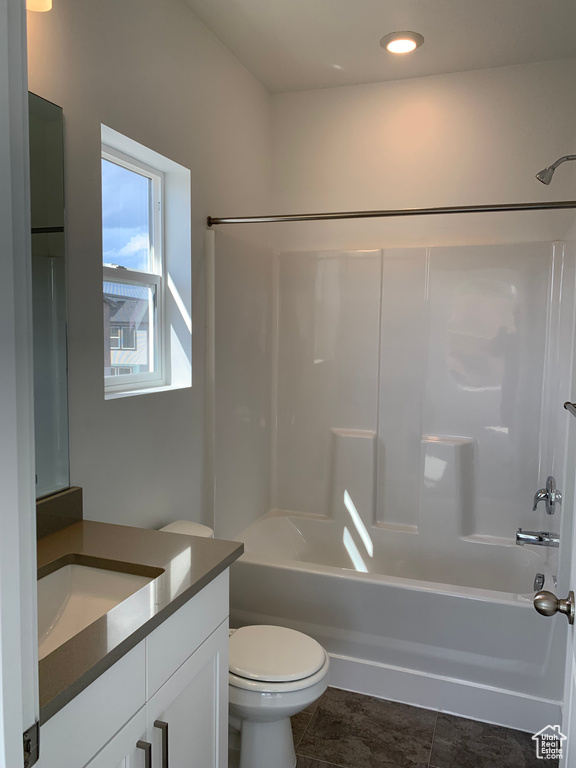 Full bathroom featuring tile flooring, vanity, toilet, and tub / shower combination