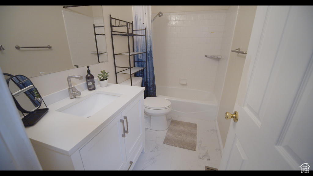 Full bathroom with tiled shower / bath, vanity, toilet, and tile flooring