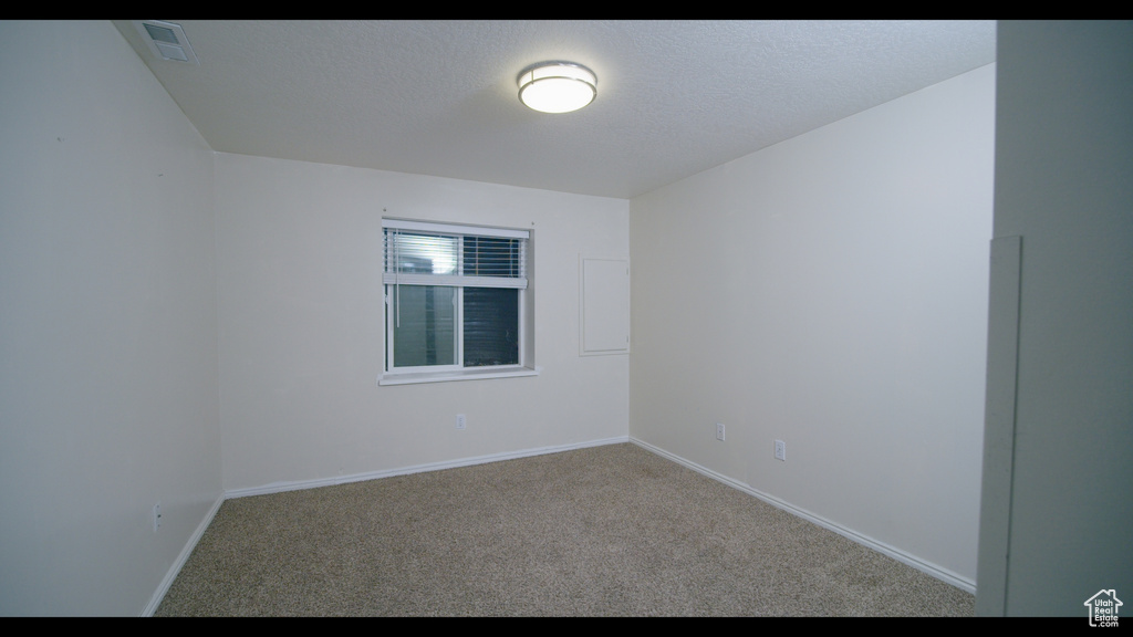 Unfurnished room featuring carpet flooring