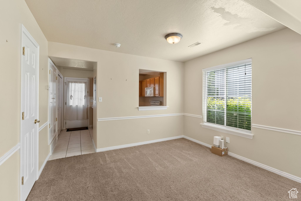 Empty room featuring light colored carpet