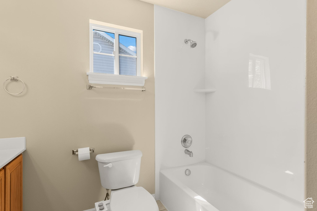 Full bathroom featuring  shower combination, toilet, and vanity