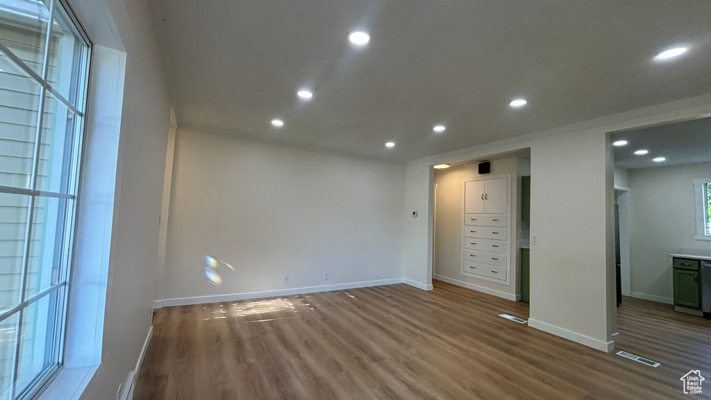 Unfurnished bedroom with hardwood / wood-style floors and ensuite bath