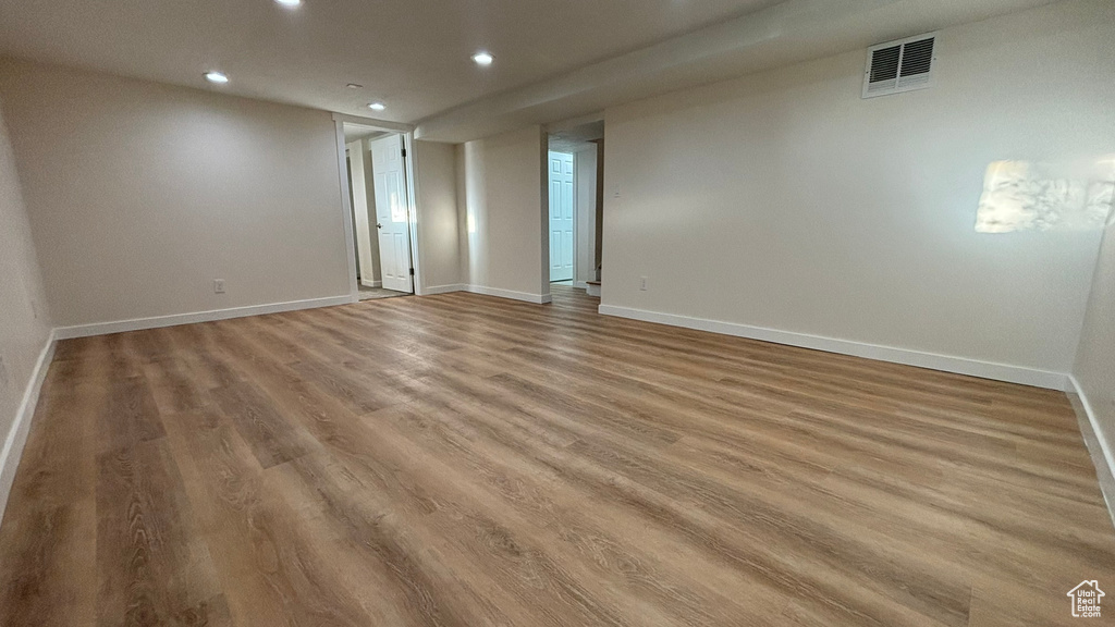 Empty room with hardwood / wood-style flooring