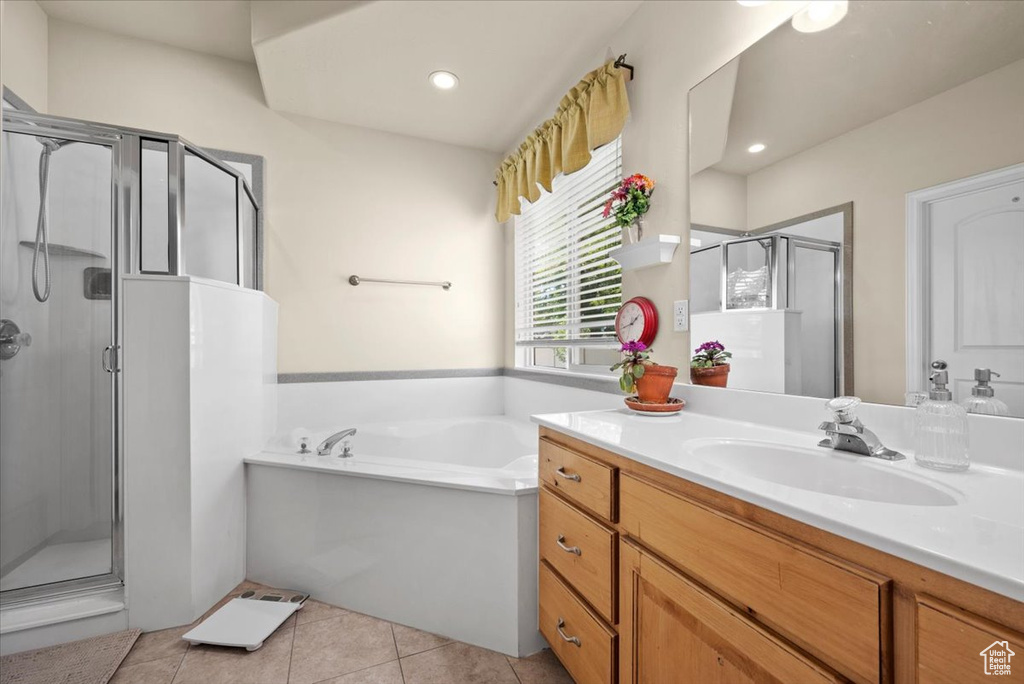 Bathroom with separate shower and tub, tile floors, and large vanity