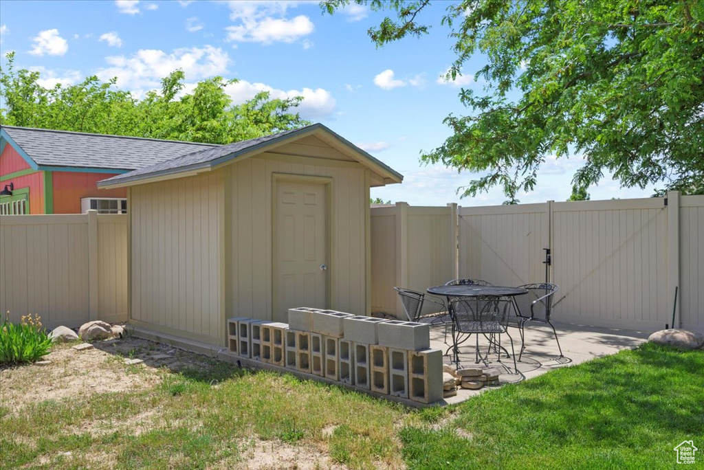 View of outdoor structure with a yard