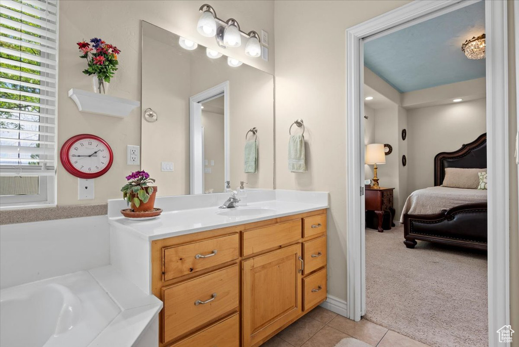 Bathroom featuring vanity, tile floors, and a bathtub