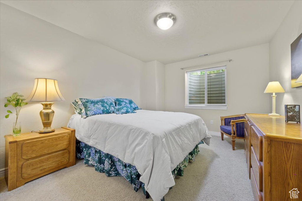 Bedroom with light colored carpet