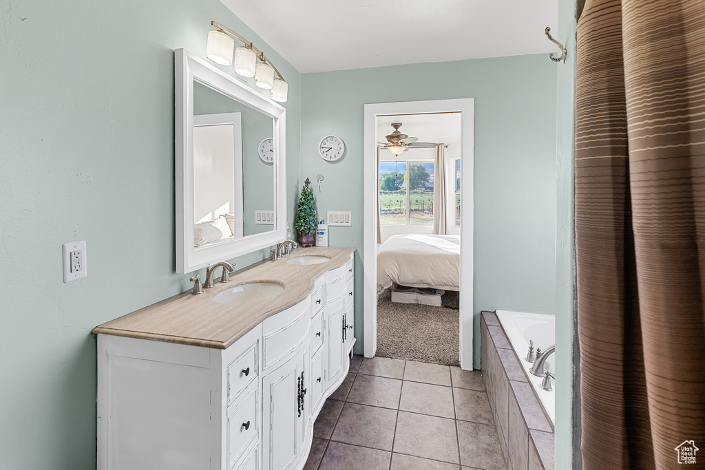 Bathroom with ceiling fan, tile floors, and large vanity