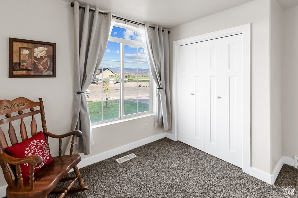 Sitting room featuring carpet flooring