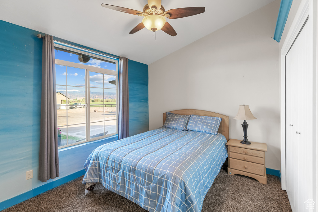 Bedroom featuring carpet, a closet, ceiling fan, and lofted ceiling