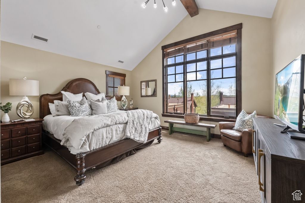 Bedroom featuring vaulted ceiling with beams and carpet floors