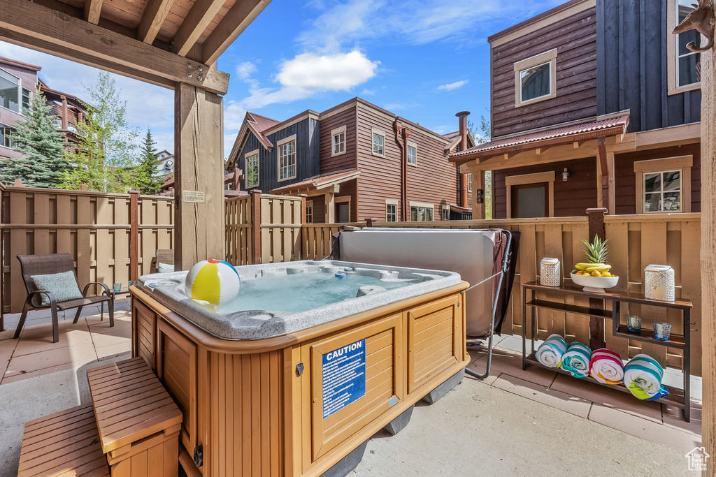 View of patio with a hot tub