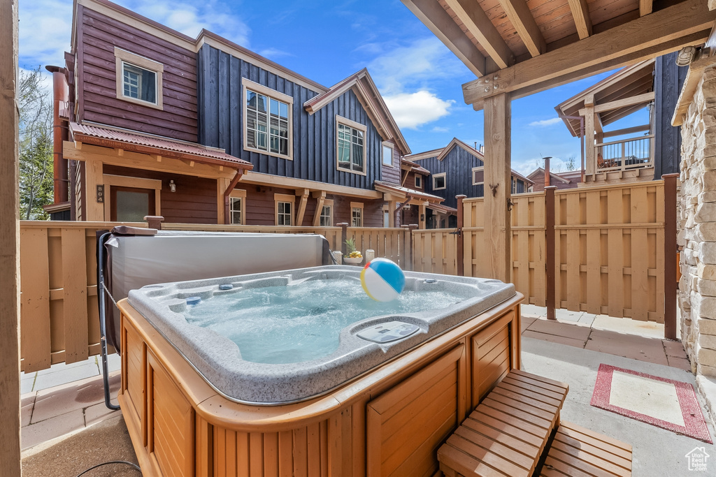 Exterior space with a hot tub