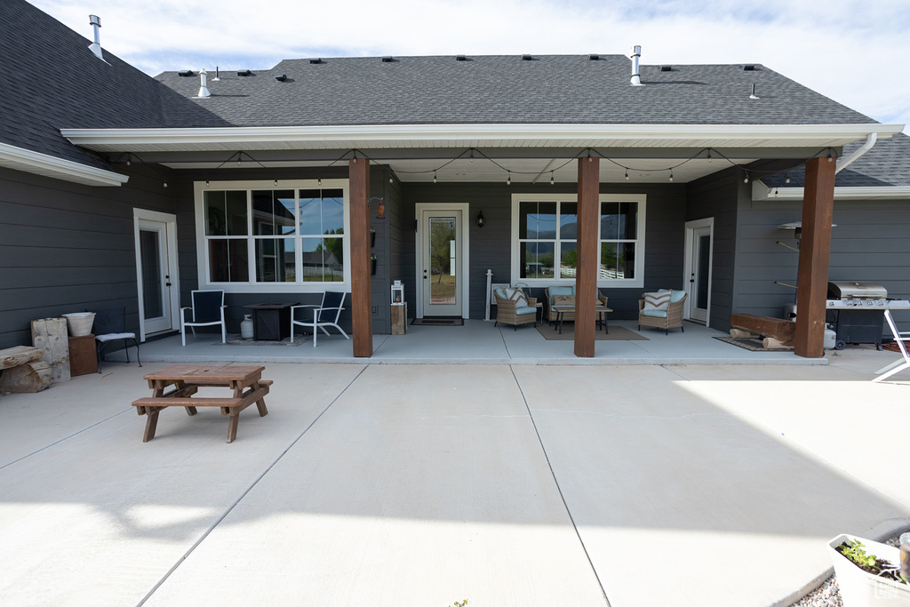 Rear view of property with an outdoor hangout area, a patio area, and french doors