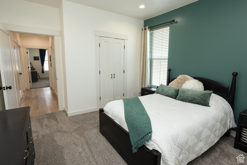 Bedroom featuring carpet and a closet