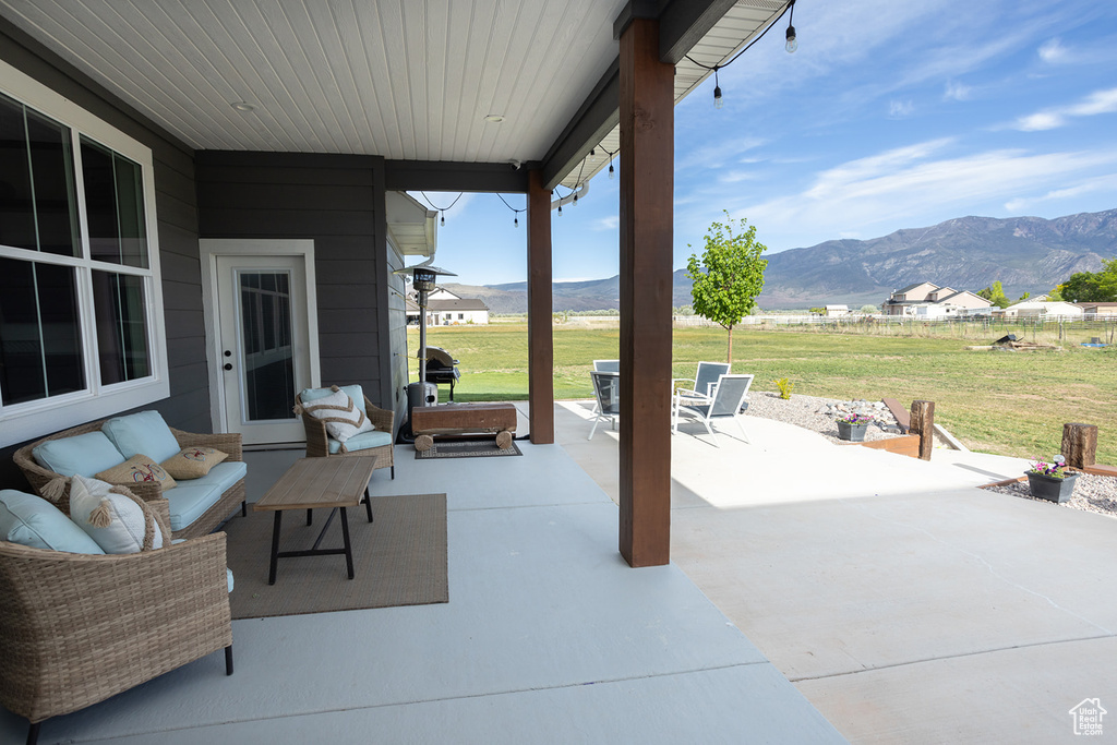 View of patio with a mountain view and outdoor lounge area