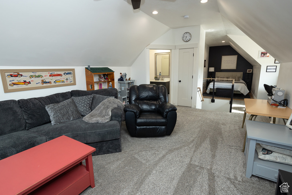 Carpeted living room with vaulted ceiling