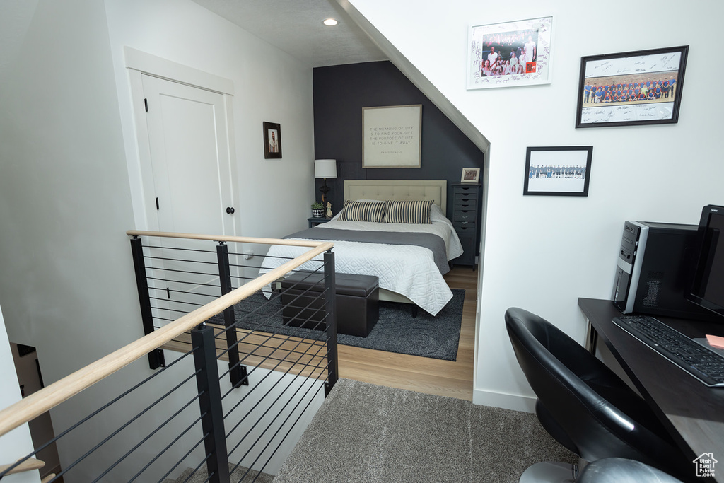 Bedroom with hardwood / wood-style flooring