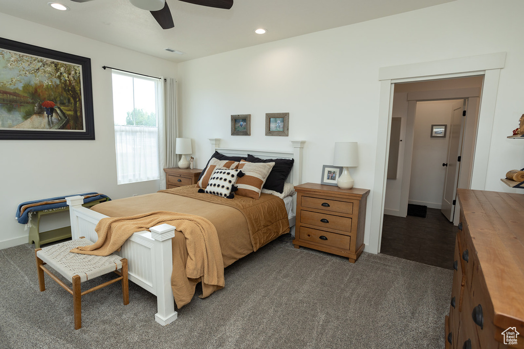 Carpeted bedroom featuring ceiling fan