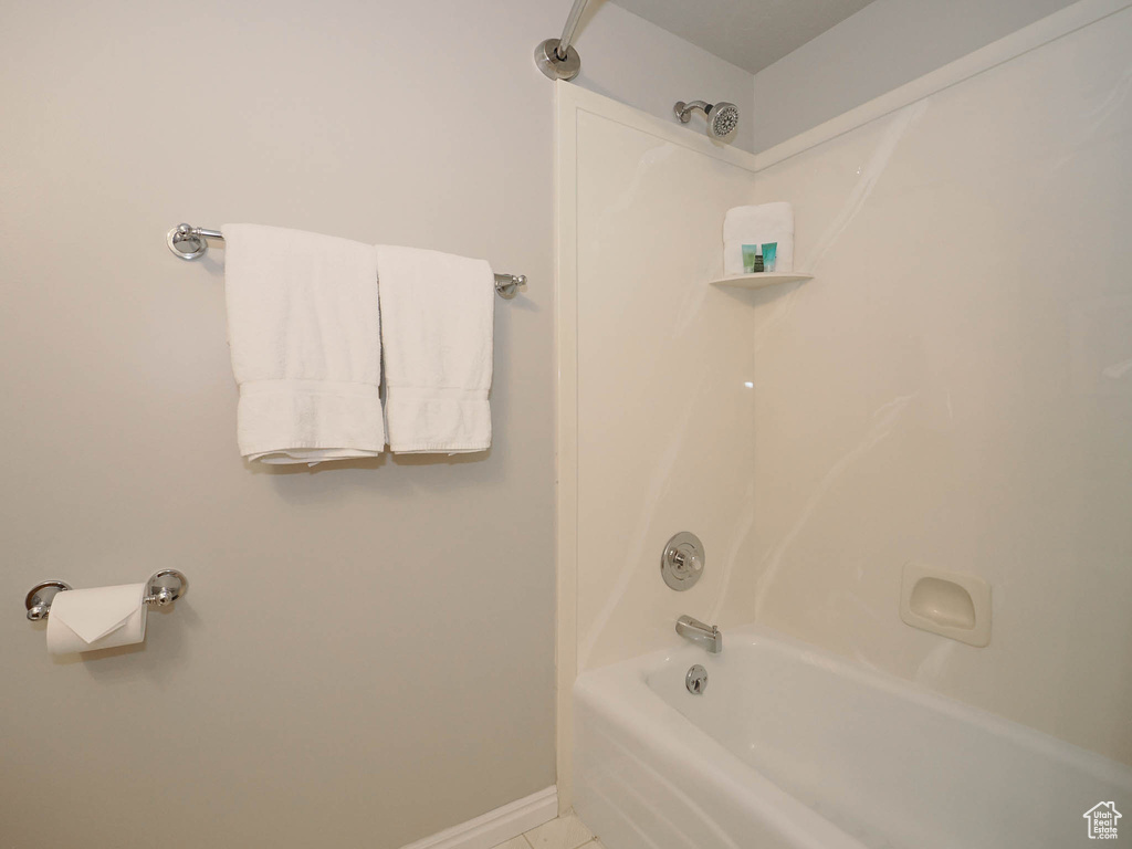 Bathroom featuring washtub / shower combination and tile flooring