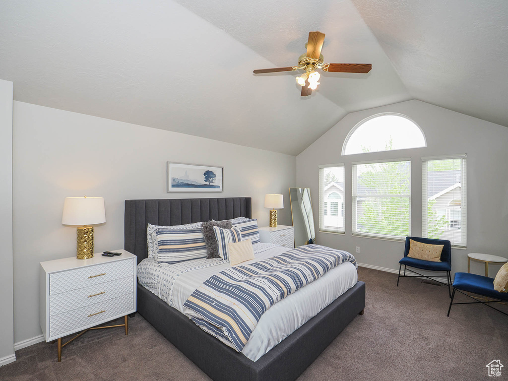 Bedroom with carpet, ceiling fan, and vaulted ceiling