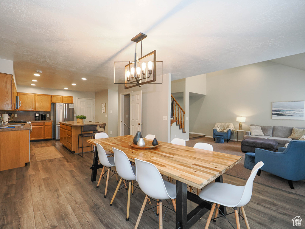 Dining room featuring dark hardwood / wood-style floors and a notable chandelier