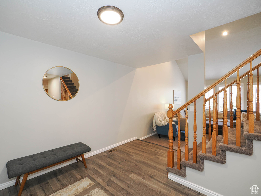 Interior space with dark hardwood / wood-style floors