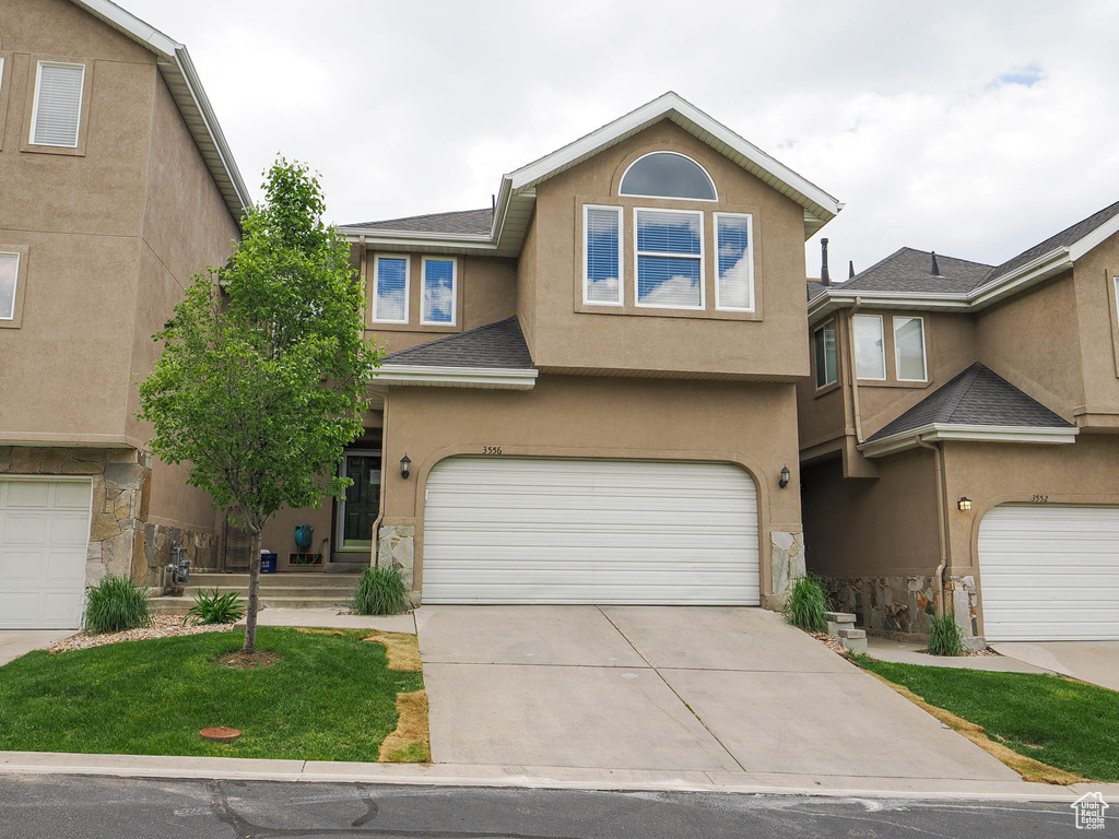 View of front facade featuring a garage