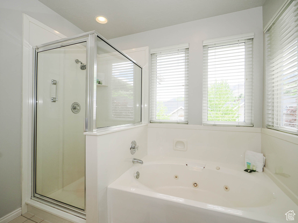 Bathroom featuring tile flooring and separate shower and tub