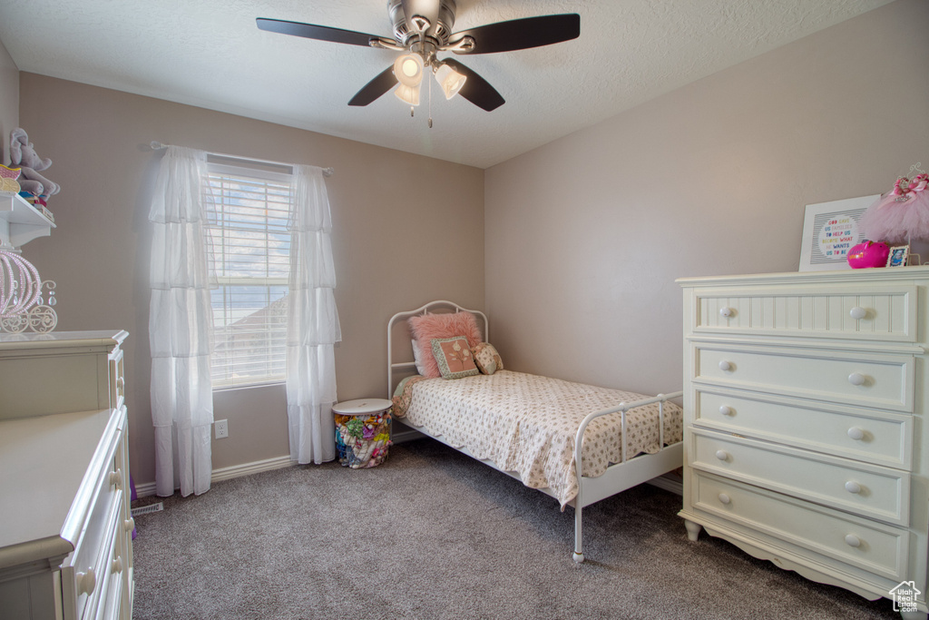 Bedroom featuring dark colored carpet and ceiling fan