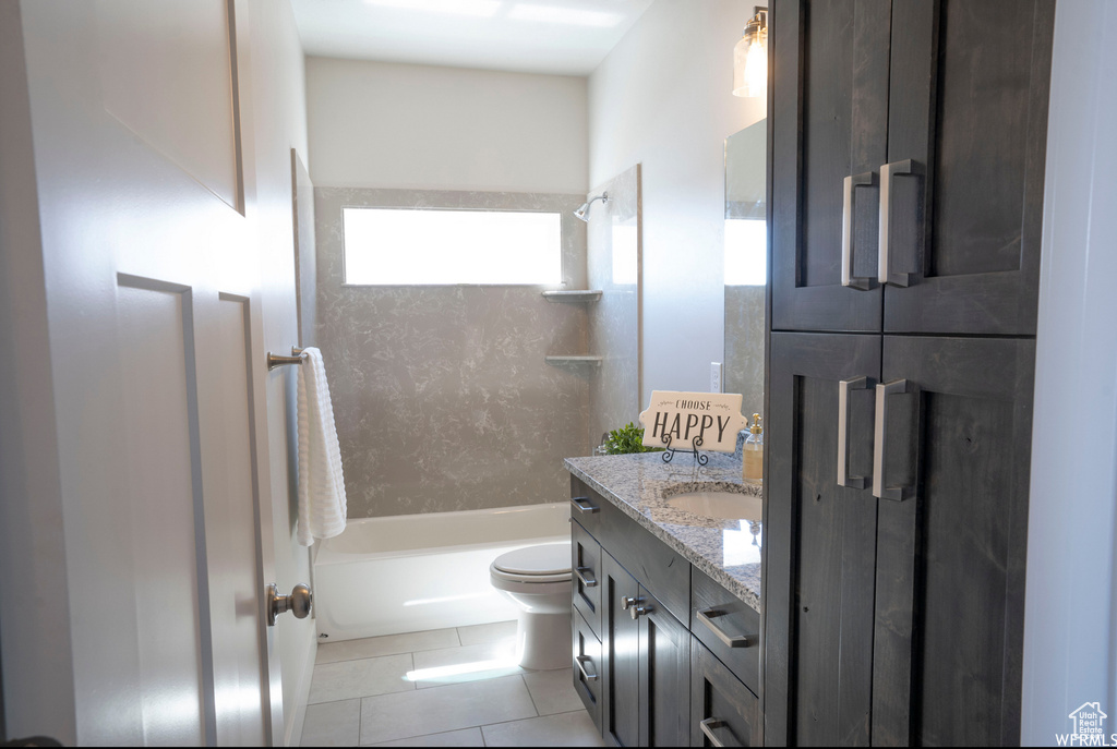 Full bathroom featuring tile flooring, vanity, toilet, and shower / bathing tub combination